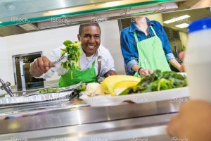 dummy_blog_stock-photo-42568976-happy-cafeteria-worker-serving-salad-to-student-in-lunch-line